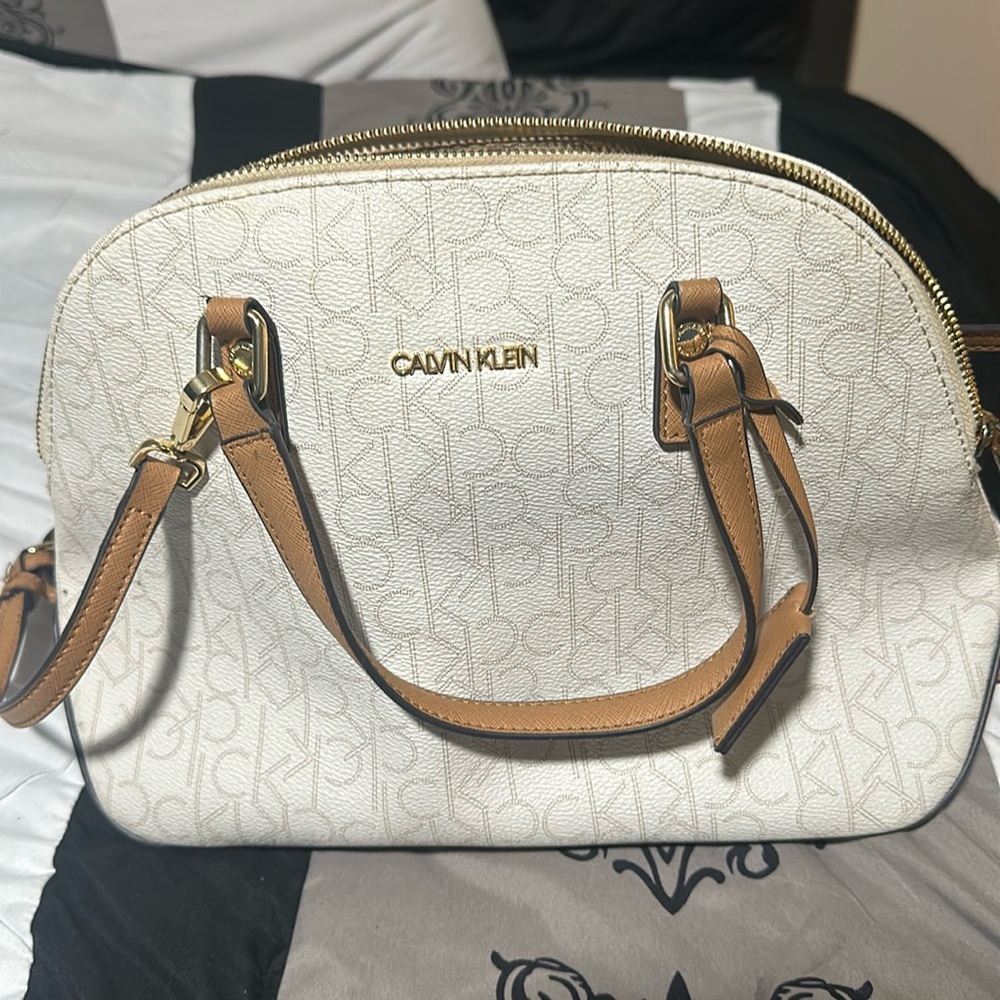 Cross body Calvin Klein bag that’s white and tan.
